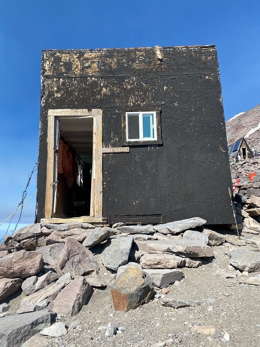 Bunkhouse at Camp Muir on gravel and rock terrain