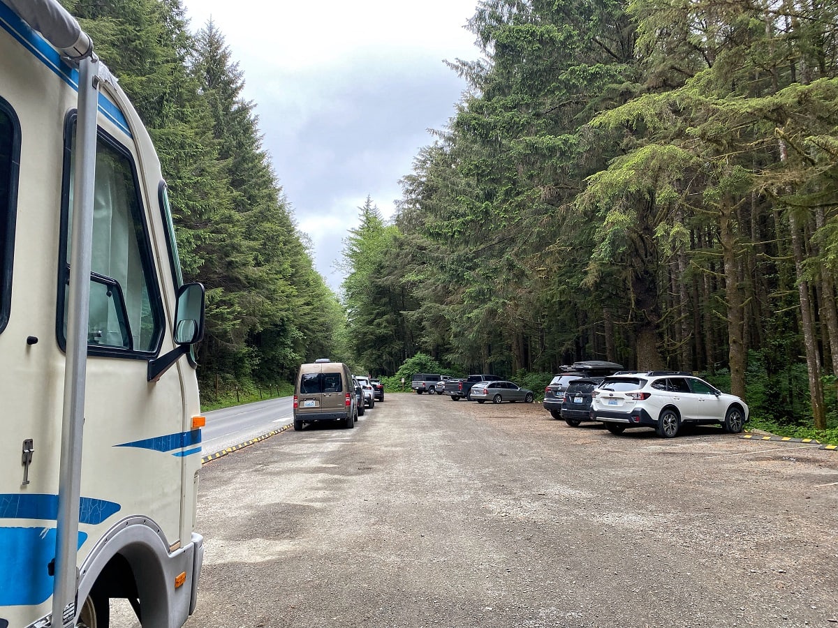 Third Beach parking lot with evergreen trees surrounding it