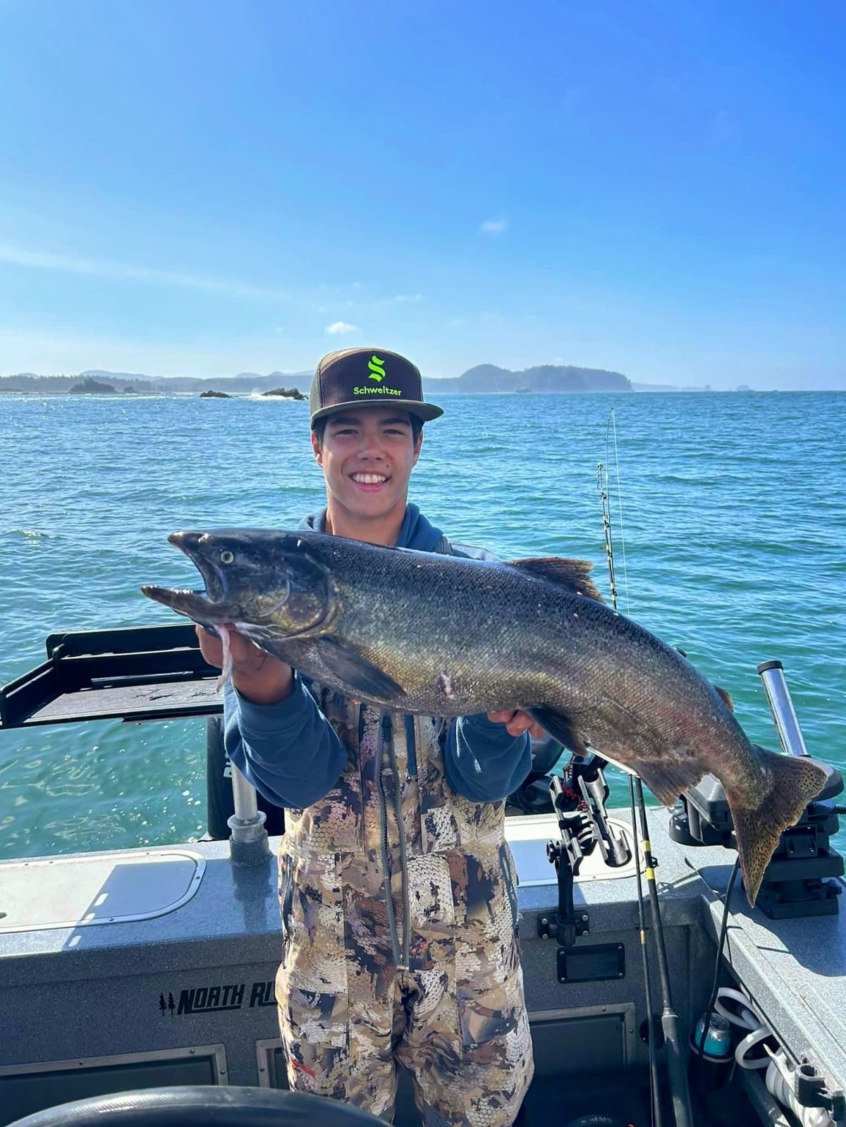 kid holding a big fish on a boat off of Neah Bay