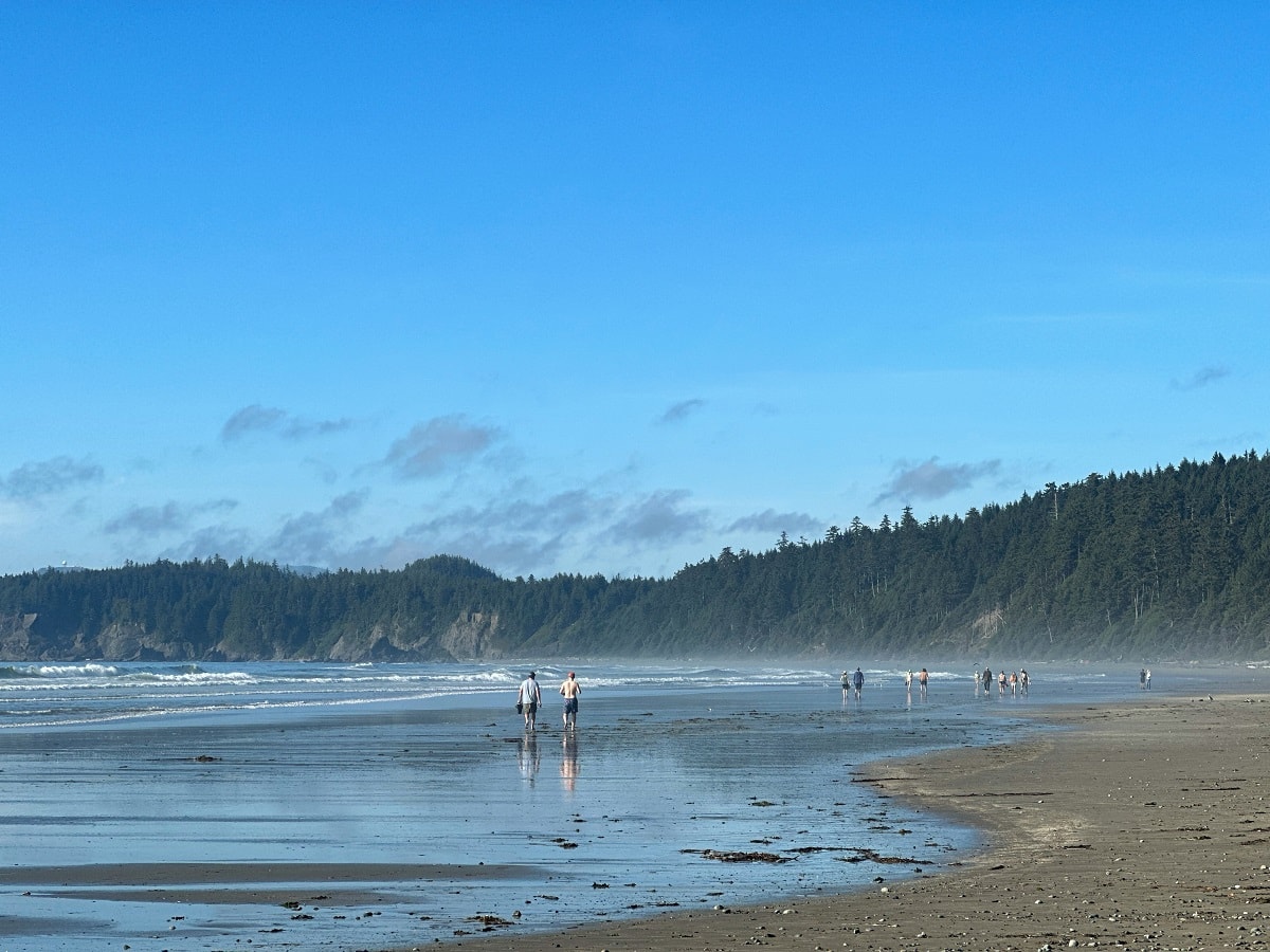 people walking on Shi Shi beach, one of the top attractions in Neah Bay